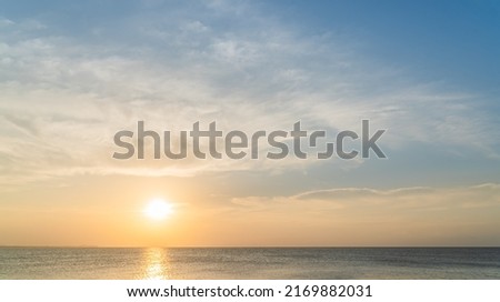 Sunset sky over sea in the evening with orange sunlight 