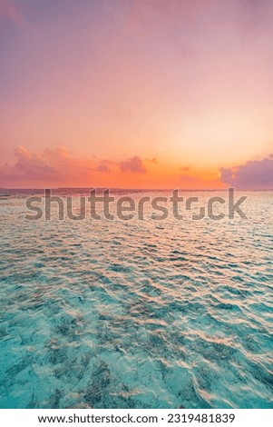 Sunset sky over sea horizon in evening. Colorful clouds orange sunlight, Dusk calm water bay sunrise sky, sun through the clouds. Meditation ocean freedom abstract nature. Tranquil panoramic seascape