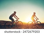 Sunset, sky and people on bicycle with adventure, race and exercise trail in nature together. Cycling, fitness and friends with mountain bike in evening for outdoor workout, blue sky and grass path