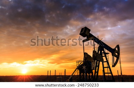 Sunset sky with profiled oil well