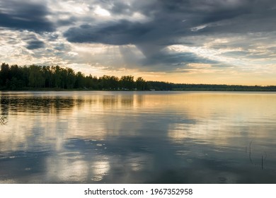 Sunset sky with rain cloud on the lake.