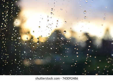 Sunset sky raindrops on window on a rainy day