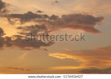sunset sky with rays of light shining down pass clouds and sky