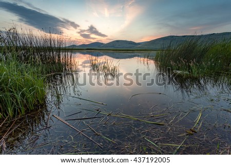 sunset sky reflect in marsh

