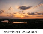 Sunset sky. Sunrise over the river. Dramatic clouds over the landscape. Nature background.