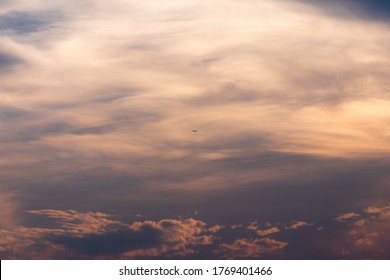 Sunset sky with super tiny little plane