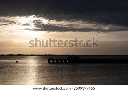 sunset sky at the tranquil river confluence of "nueva palmira", uruguay
