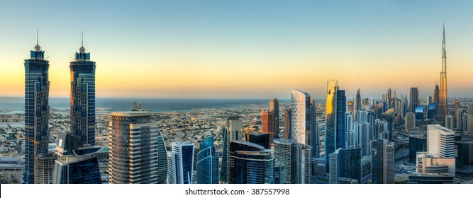 Sunset skyline with modern skyscrapers in Dubai, UAE. Aerial  view of business bay's architecture. 