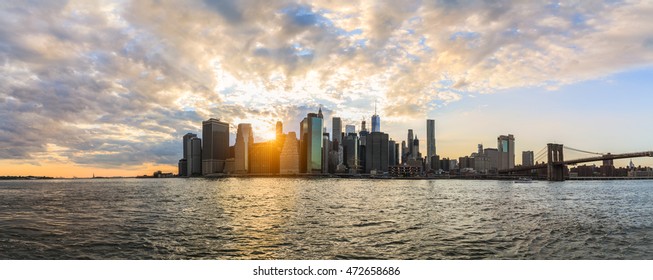 Sunset Skyline of New York - view of Brooklyn Bridge and buildings in Manhattan