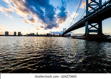 Sunset Skyline Of Philadelphia Pennsylvania From Camden New Jersey With Benjamin Franklin Bridge