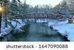 Sunset Snowy Footbridge over River