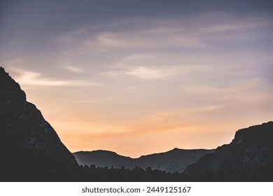 Sunset soft sky in the mountains at sunset for background, sky gradient in the evening among mountain ranges