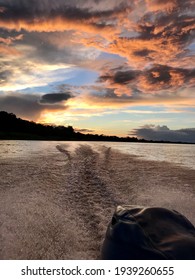 Sunset At The Stern Of A Motorboat On The Madeira River.