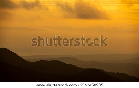 Sunset with stormy cloud sky and dramatic orange sunlight above mountain. Troodos mountains Cyprus