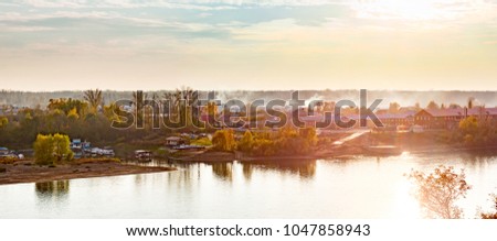 Sunset summer panorama on the Ufimka River from the opposite shore.