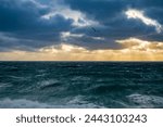 Sunset with sun beams and storn at sea