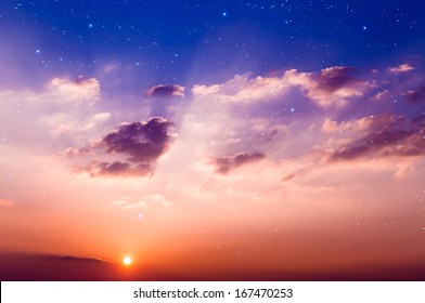  Sunset With Sun, Clouds And Light Rays. With Stars On Background. 