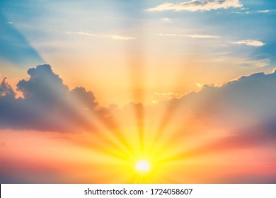 Sunset with sun and clouds on blue and orange dramatic sky with sun rays - Shutterstock ID 1724058607