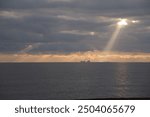 Sunset: sunlight pierces the clouds above Dungeness B power station at Romney Marsh on the Kent coast 