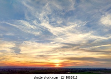 A sunset in a sunny day with a blue sky and clouds in the Galacho del Juslibol rural area, Zaragoza, Aragon region, Spain