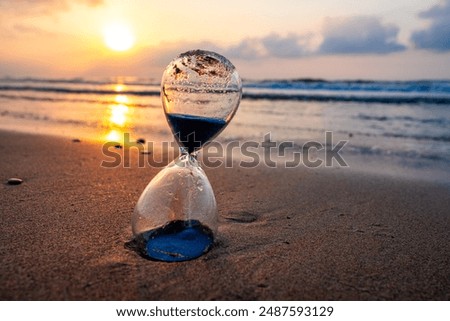 Sunset or sunrise, hourglass on the seashore