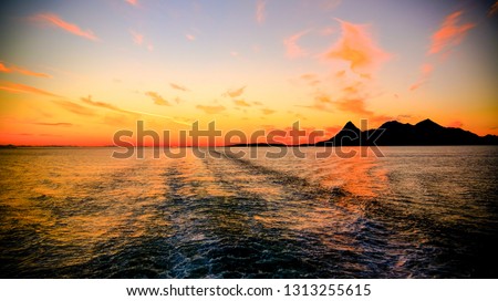 Sunset and sunrise over the sea and Lofoten archipelago from the Moskenes - Bodo ferry in Norway