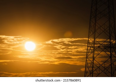 Sunset or sunrise in a spring field with shadows grass, willow trees and cloudy sky. Sunbeams making their way through the clouds. soft focus sunset on orange sky. image of natural.