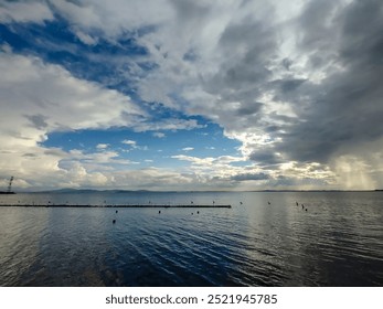 Sunset or sunrise with stormy clouds over the Black sea near the town of Pomorie in Bulgaria. Beautiful seascape from the shore.