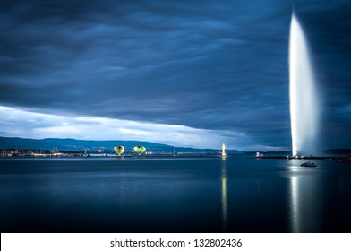 Sunset or sunrise view of the famous fountain in Geneva city in lake Geneva. Blue clouds in background. Switzerland, Europe.