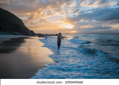 Sunset Surf Fishing - April 10, peoples are catching fish on the shoreline at the little Wategos beach on April 10, 2018 in Byron Bay, New South Wales, Australia
