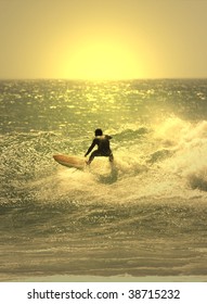sunset surfer in the wave