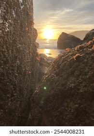 Sunset Though the Rocks on the Beach.