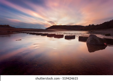 Sunset at Three Cliffs Bay 
Sunset at the stepping stones that allow access to the divided beaches at Three Cliffs Bay on the Gower peninsula in Swansea, South Wales