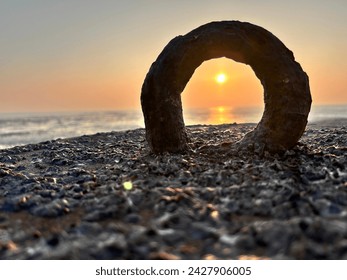 Sunset through a Loop in a Beach