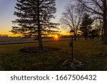Sunset through the trees in winter