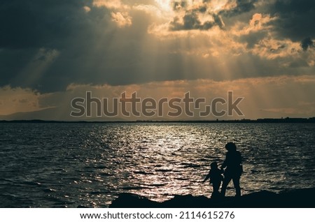 sunset time reverse light silhouette people clouds boats