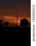 Sunset with tower and tree