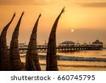 The sunset with traditional boat craft at Huanchaco town, near Trujillo, Peru