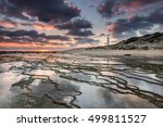 Sunset at Trafalgar beach, nearby lighthouse, where the great battle of Trafalgar took place. Costa de la Luz, Cadiz, Spain