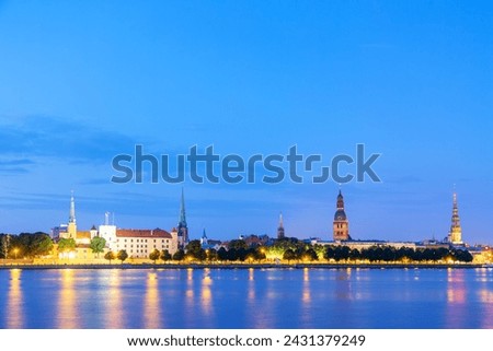 Sunset twilight view of Riga cityline panorama over river Daugava with old town