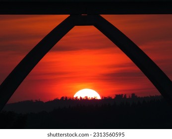Sunset under a bridge with forest