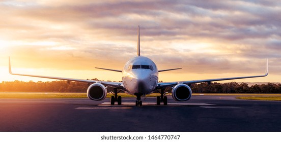 Sunset view of airplane on airport runway under dramatic sky in Hobart,Tasmania, Australia. Aviation technology and world travel concept. - Powered by Shutterstock