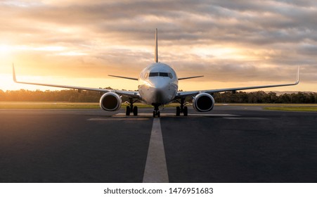 Sunset view of airplane on airport runway under dramatic sky in Hobart,Tasmania, Australia. Aviation technology and world travel concept. - Powered by Shutterstock