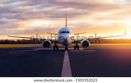Sunset view of airplane on airport runway under dramatic sky in Hobart,Tasmania, Australia. Aviation technology and world travel concept.