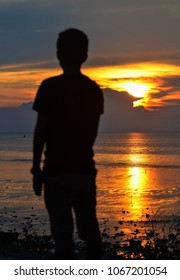 Sunset view from the beach with a man