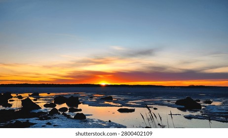 Sunset view in the beach. Sunlight reflection on the body of sea water.