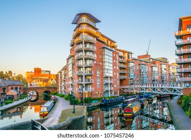 Sunset view of brick buildings alongside a water channel in the central Birmingham, England
