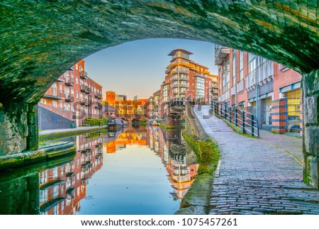 Sunset view of brick buildings alongside a water channel in the central Birmingham, England