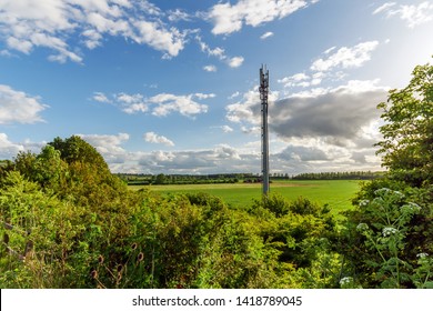 Sunset view British Mobile Operator Mast over field