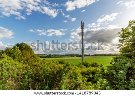 Sunset view British Mobile Operator Mast over field
